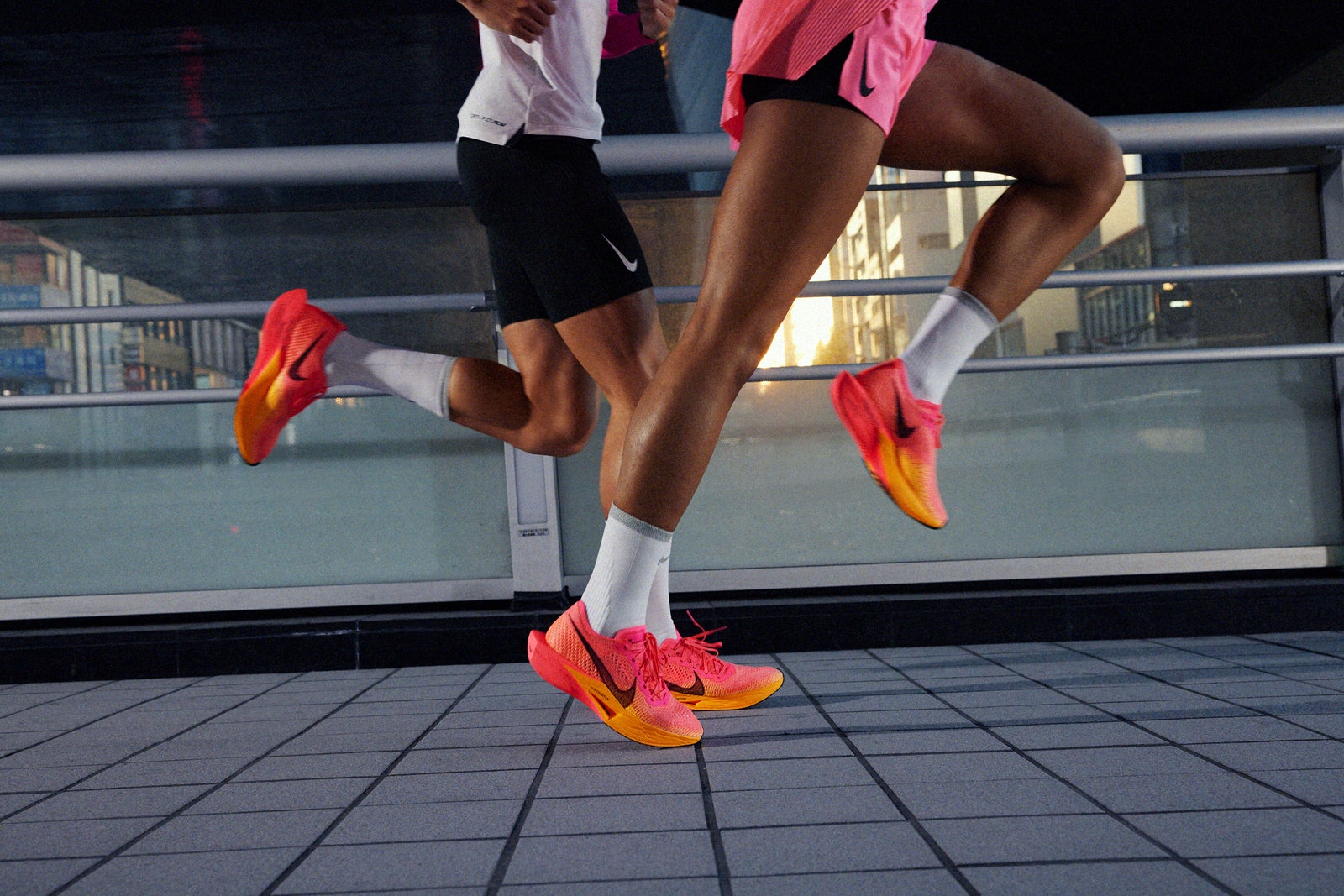 Two people running in the Nike ZoomX VaporFly Next running shoes